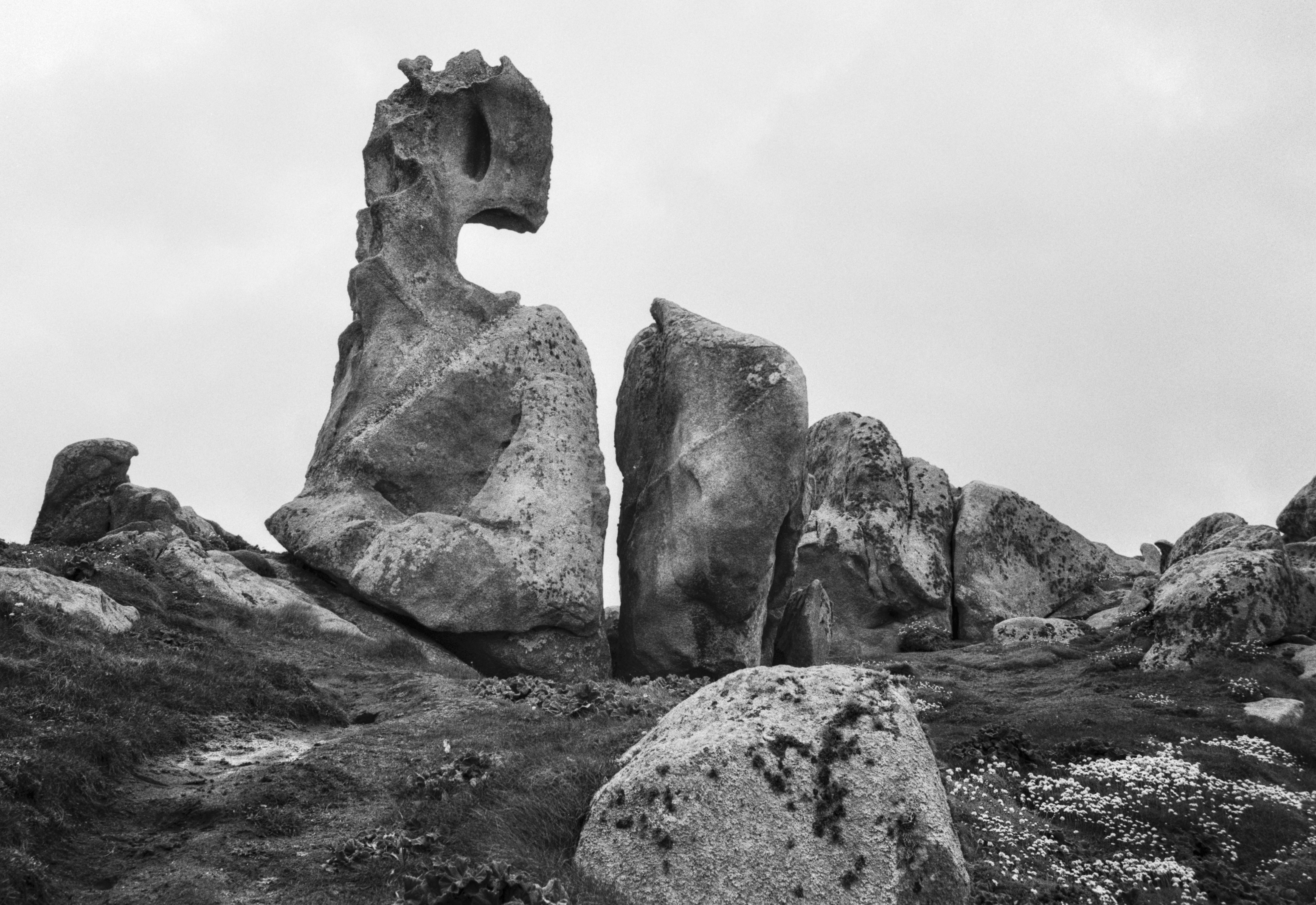 Rock formations shaped by wind and erosion near Punta Nariga lighthouse on the Galician coast.